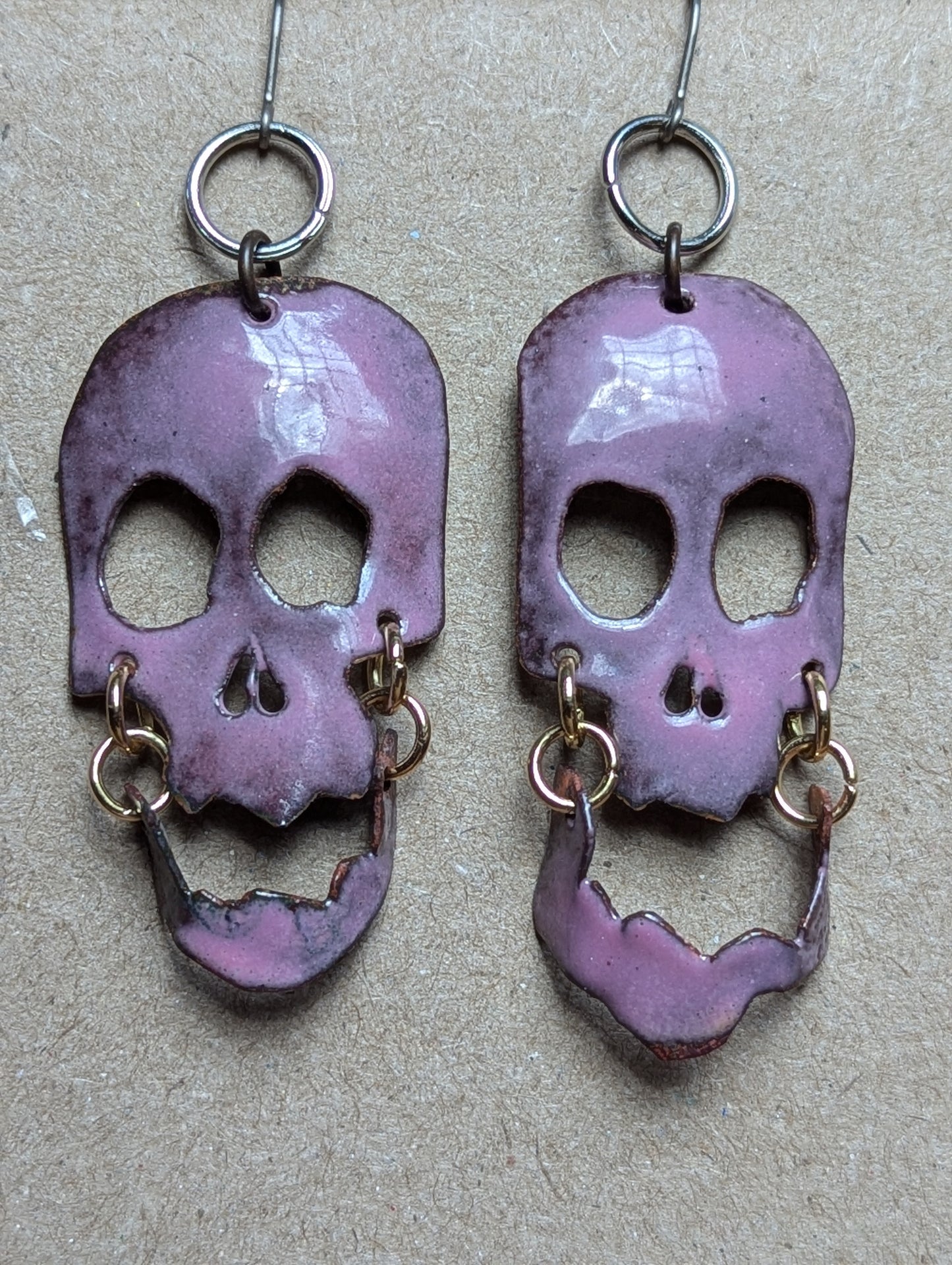 Skully earrings with halo and flair for days. Enameled hand formed copper with moving jaws