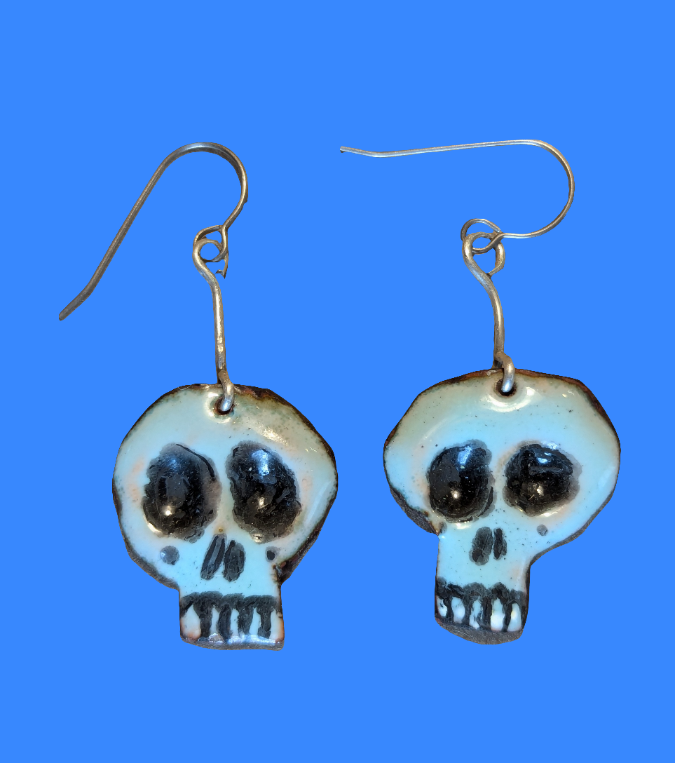 Super cute Skully earrings. Enameled copper with sterling silver accent wire.