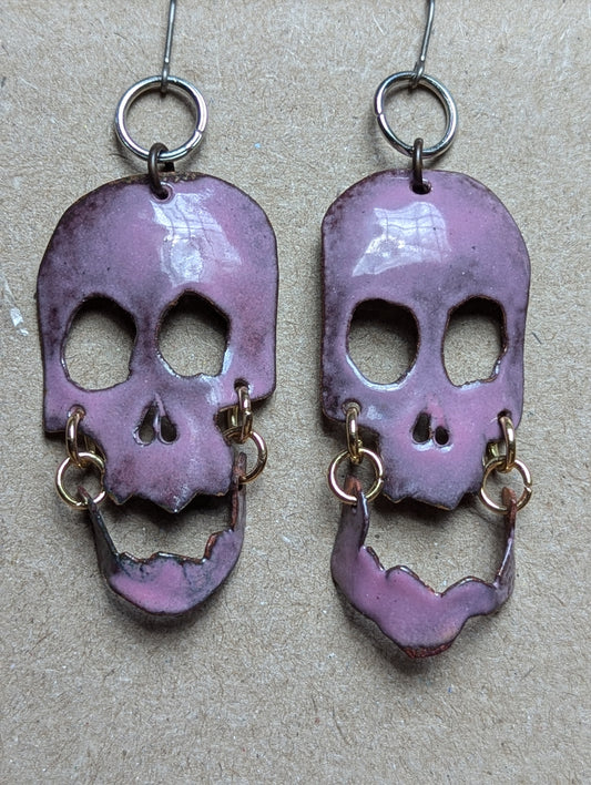 Skully earrings with halo and flair for days.  Enameled hand formed copper with moving jaws