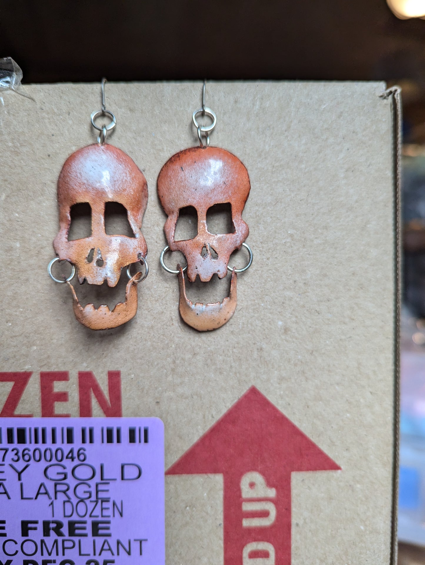 Skully earrings in translucent enamel letting the brushed copper shine through.