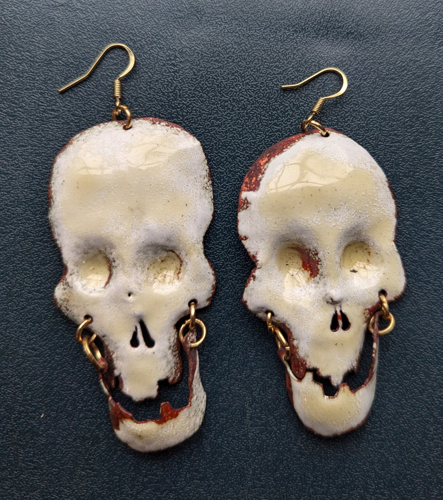 Big skull earrings: handmade, torch fired enamel, swinging jaws