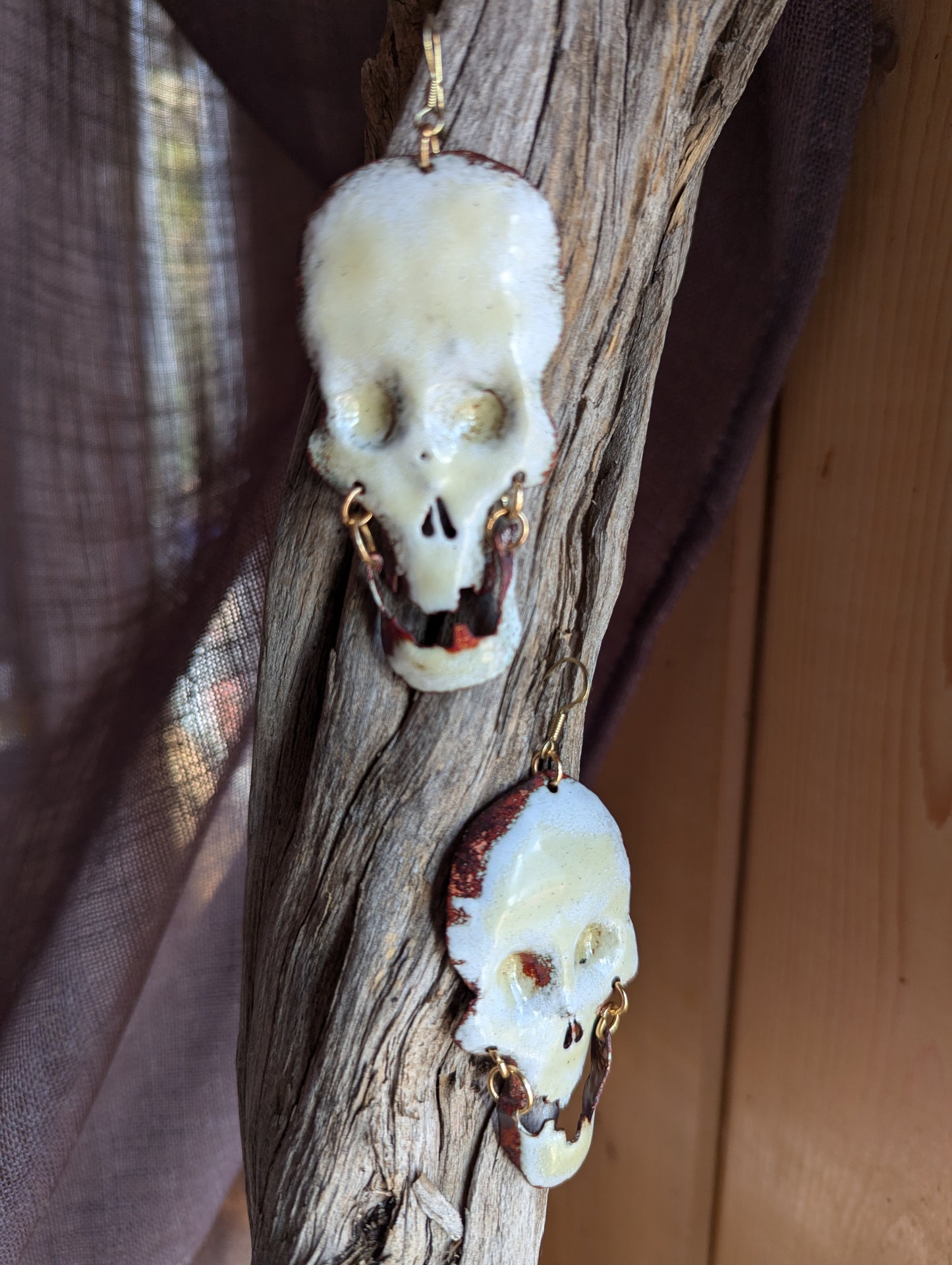 Big skull earrings: handmade, torch fired enamel, swinging jaws