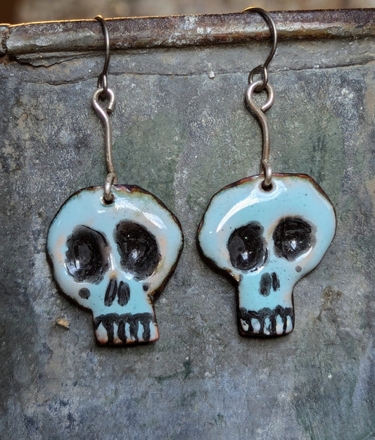 Super cute Skully earrings.  Enameled copper with sterling silver accent wire.