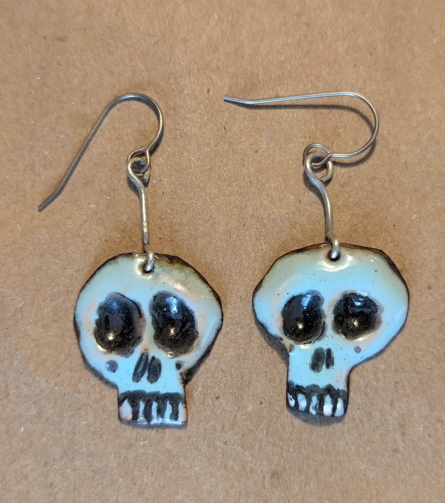 Super cute Skully earrings.  Enameled copper with sterling silver accent wire.