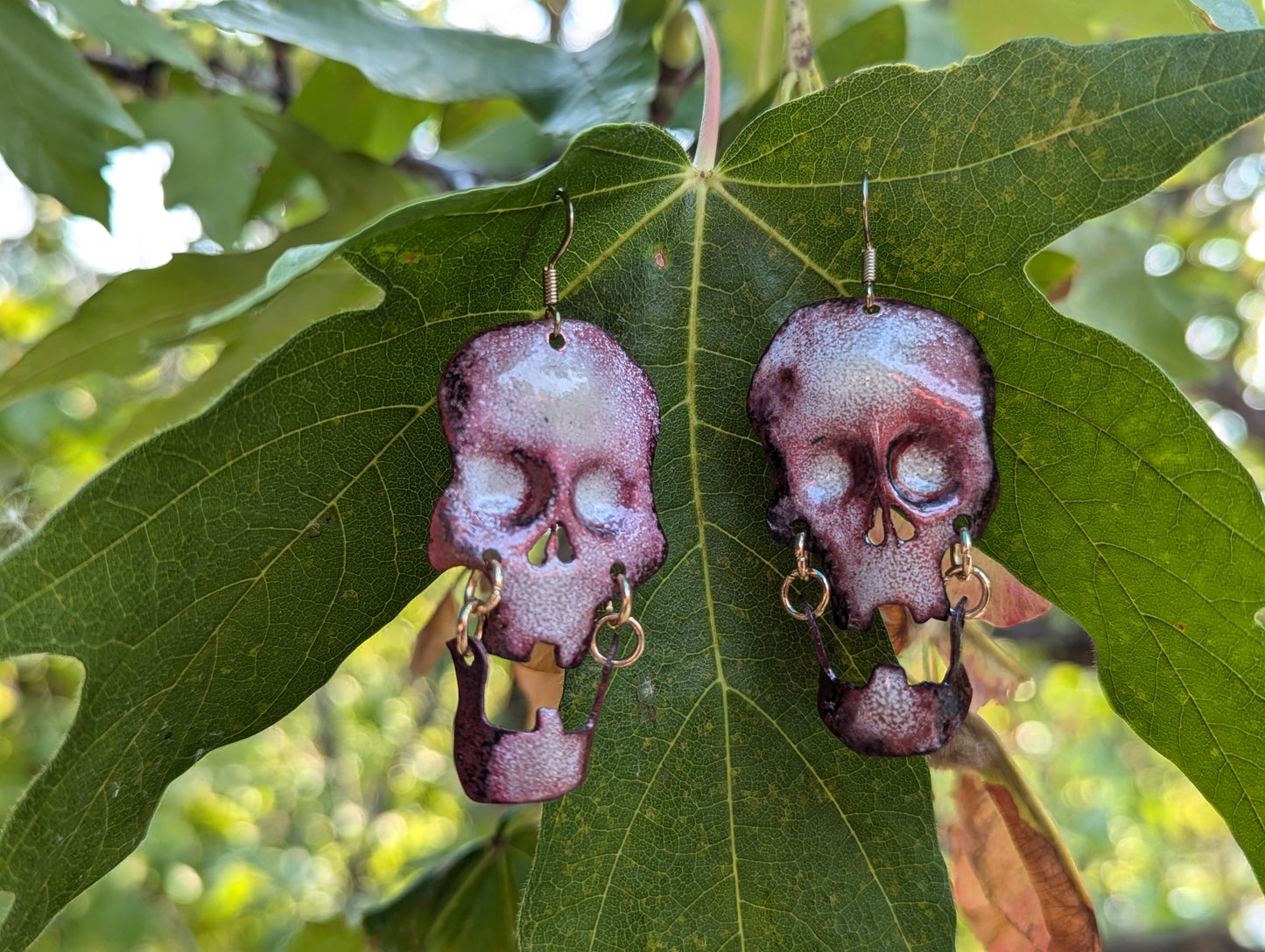 Skull earrings: handmade, torch fired enamel, swinging jaws