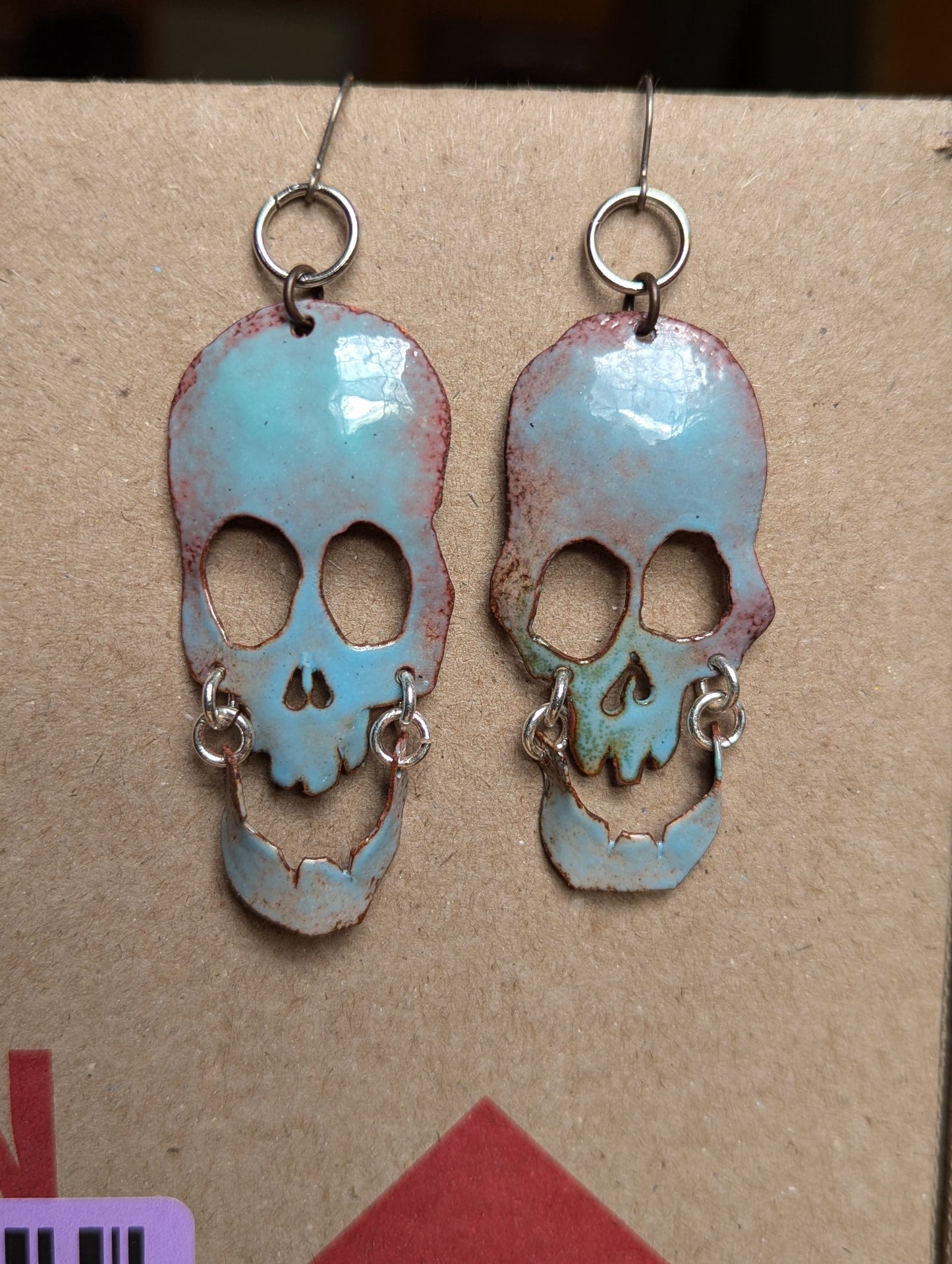 Halo Skully, enameled copper statement earrings with swinging jaws