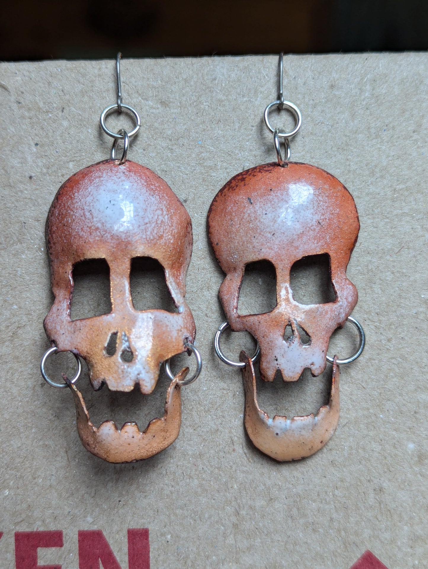 Skully earrings in translucent enamel letting the brushed copper shine through.